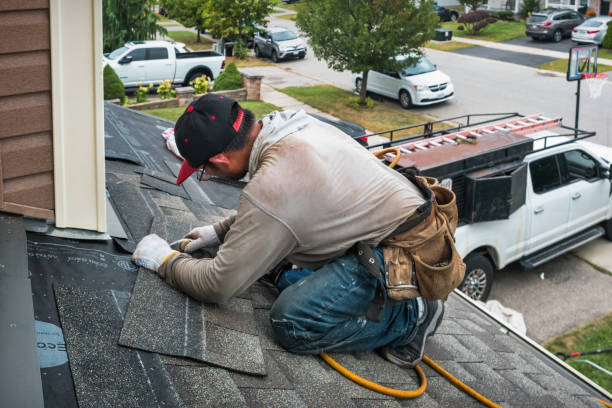 Professional Roof Replacement technician working in Elwood, NY